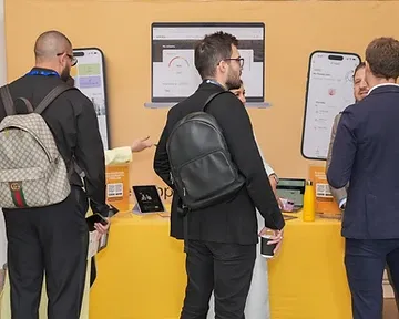 Visitors interacting at a branded exhibition booth during a trade show in Riyadh