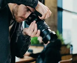 Professional photographer shooting with a DSLR in a studio workspace in Dammam