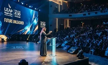 Conference photographer capturing a keynote speaker on stage in Riyadh