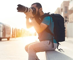 Photographer shooting with a telephoto lens at golden hour in AlUla